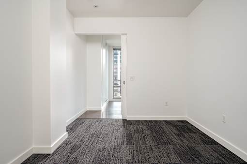 A long hallway with a door at the end.