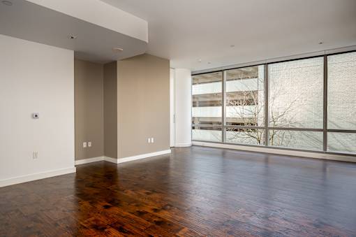 A room with wooden floors and a large window.