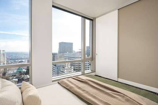 A room with a large window overlooking a cityscape.