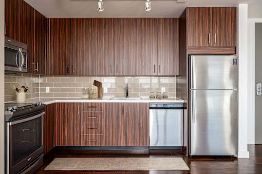 A modern kitchen with wooden cabinets and stainless steel appliances.