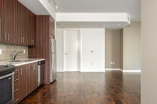 A kitchen with wooden cabinets and a white fridge.