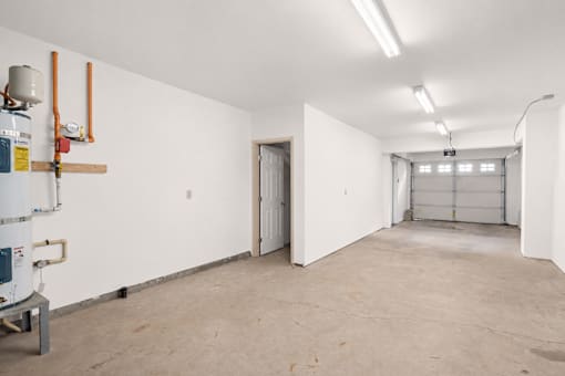 a large garage with white walls and a door