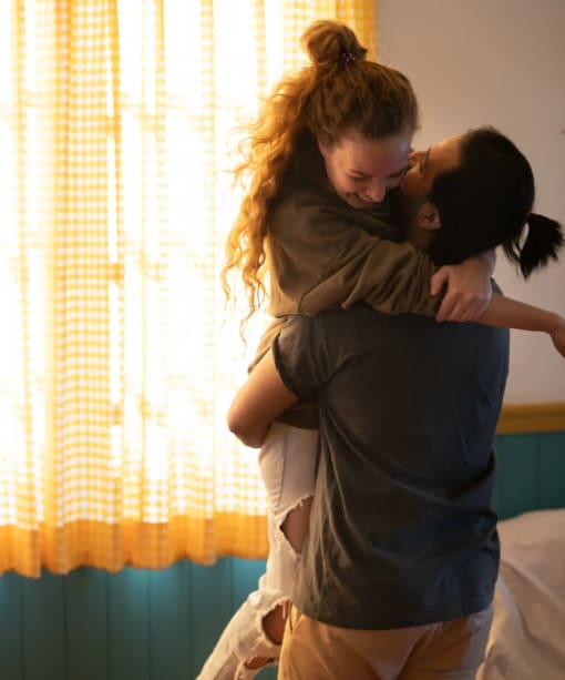 a couple hugging in a hotel room