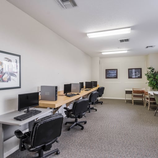 a computer lab with computers and chairs