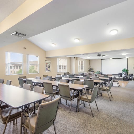 a large conference room with tables and chairs