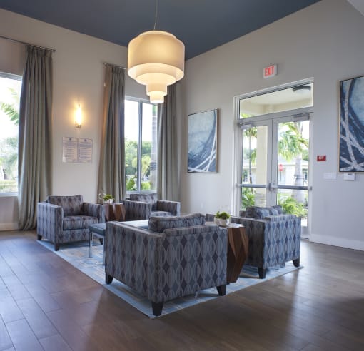 a lobby with couches and chairs and large windows