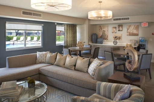 a living room with couches and chairs and a dining table