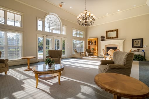 a living room filled with furniture and a large chandelier