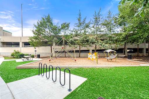 A playground with a swing set and a slide.