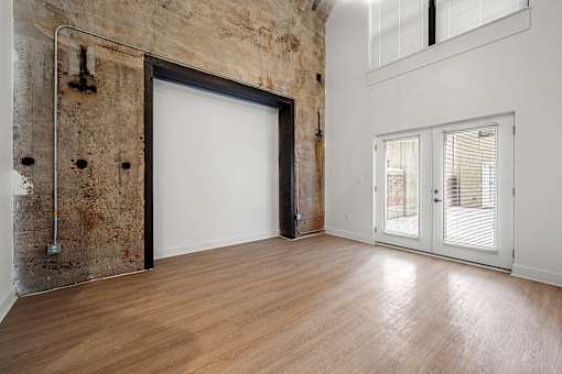 A room with a white door and a window with blinds.