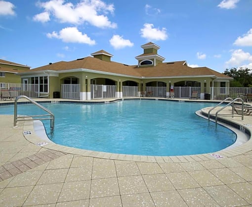 a large swimming pool in front of a house