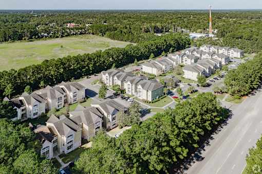 A large group of houses are clustered together in a suburban area.