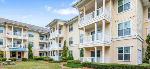 a row of apartments with balconies and a yard