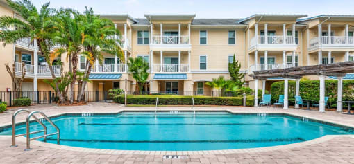 a large swimming pool in front of an apartment building