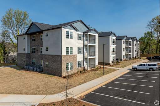 A row of townhouses with a white van parked in the driveway at Dunean Creek Apartments, Greenville, SC