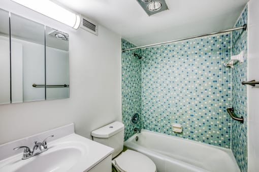 a bathroom with a sink toilet and bathtub