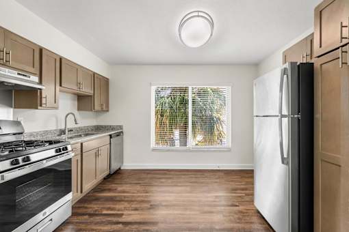 A kitchen with wooden cabinets and a white fridge.