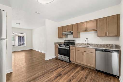 A kitchen with wooden cabinets and stainless steel appliances.