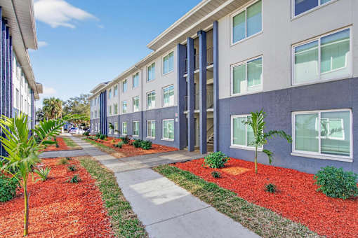 A long building with a red mulch strip in front.