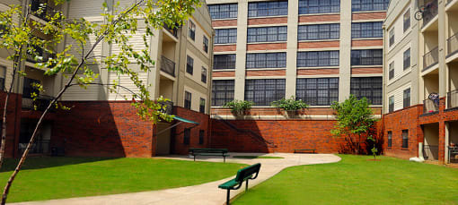 a bench in a courtyard in front of an apartment building