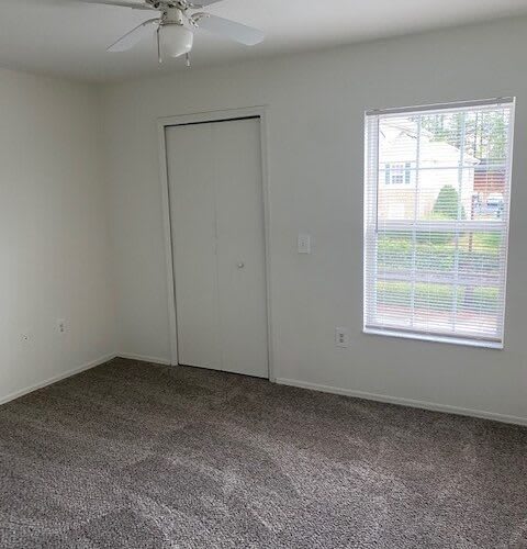 an empty room with a door and a window