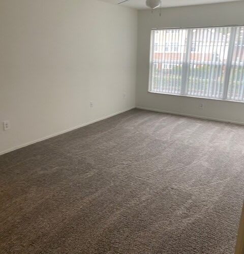 an empty living room with a large window