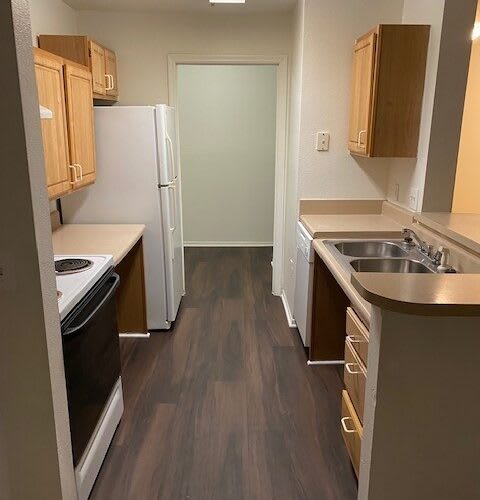 a small kitchen with a sink and a refrigerator