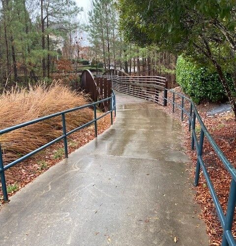 a path in a park with a fence