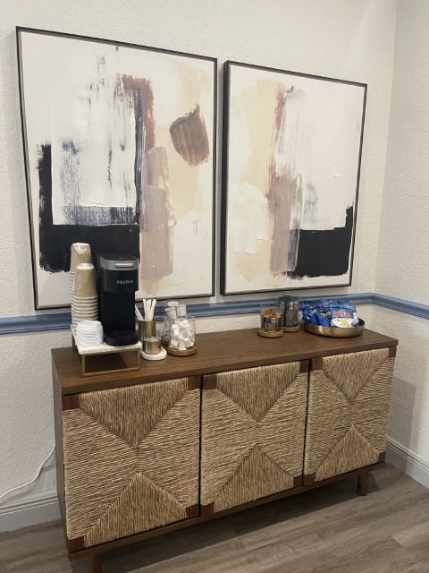 two canvases of paint on a table with a paint brush