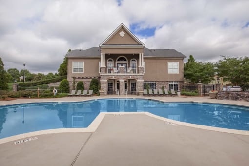a large swimming pool in front of a house at Carrington Place at Wildewood, Columbia, SC  