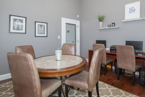 a dining room with a table and chairs and a television at Carrington Place at Wildewood, South Carolina   