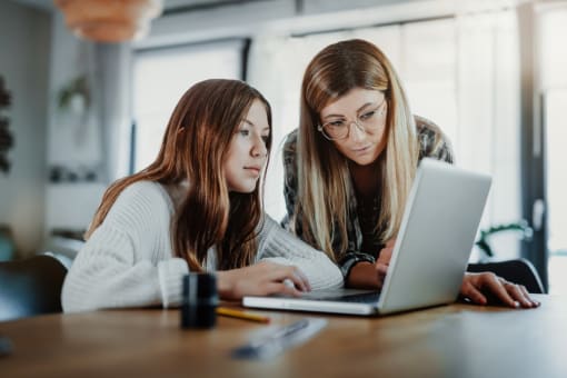a group of women working on laptops