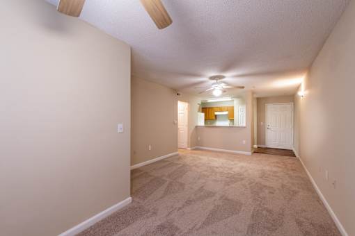 A room with a carpeted floor and a ceiling fan at Lakeside Gardens Apartments, Durham