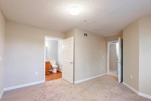 A room with a carpeted floor and a toilet in the corner at Lakeside Gardens Apartments, Durham, NC, 27713