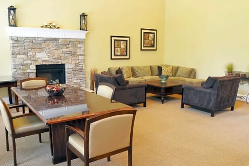 a living room with a couch and a table and a fireplace