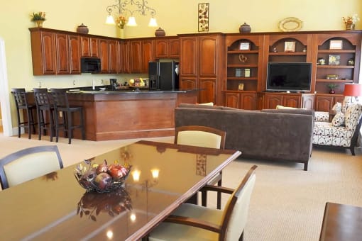 a living room and kitchen with a table and chairs