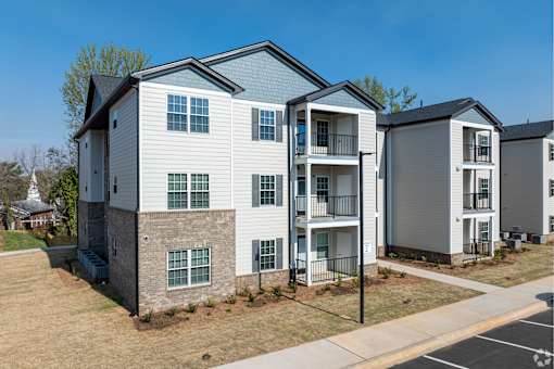 A row of modern townhouses with balconies and garages at Dunean Creek Apartments, Greenville, 29611