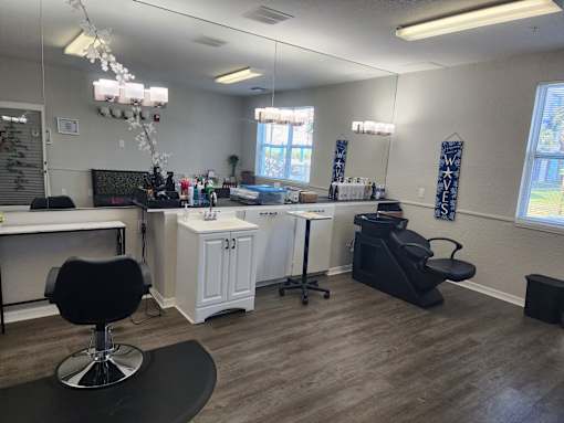 A room with a black chair and a white cabinet.