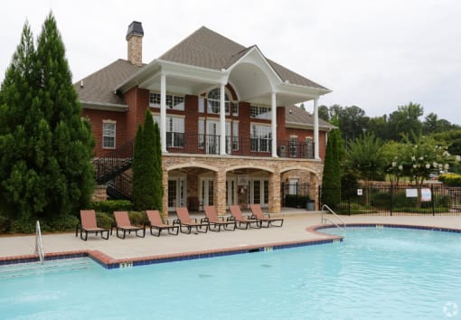 a large swimming pool in front of a house at Magnolia Lake Apartments, Carrollton, GA, 30117