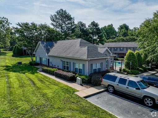 A house with a car parked in front.