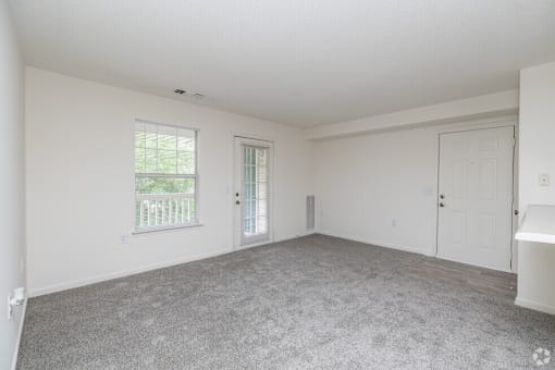 Empty room with white walls and carpet.