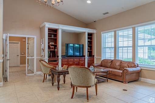A living room with a brown leather couch and a wooden coffee table.