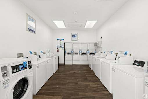 A row of washing machines in a laundromat.