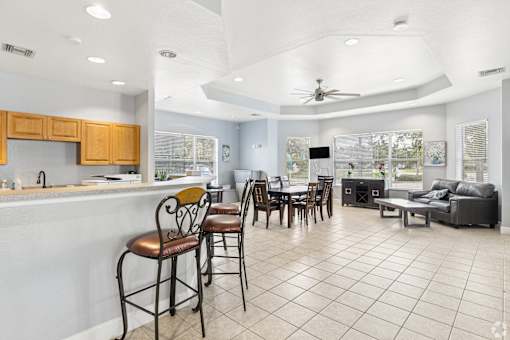 A kitchen with a bar area and a dining table.
