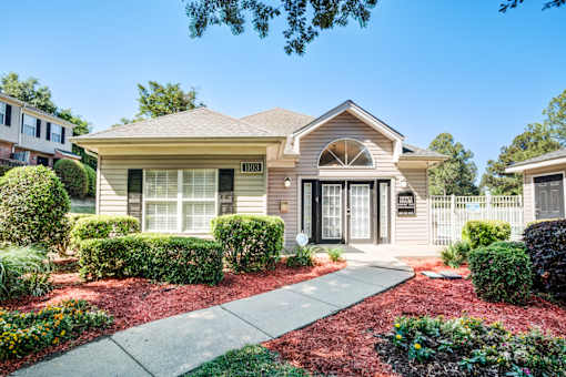 A house with a front yard and a driveway.