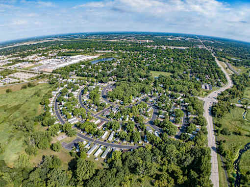 an aerial view of a city with a parking lot    and a highway