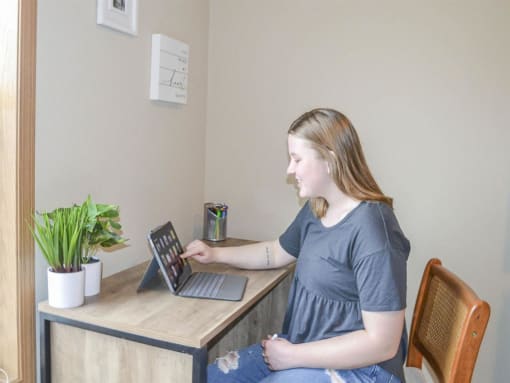 a woman sitting at a desk with a laptop computer at Boulder Ridge, Minnesota, 55811