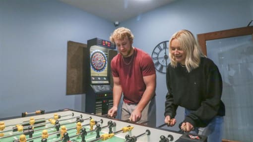 a man and a woman standing next to a foosball table at Boulder Ridge, Duluth, MN