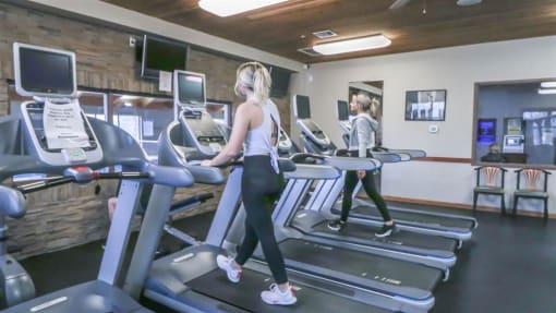 a woman walking on a treadmill in a gym at Boulder Ridge, Duluth Minnesota