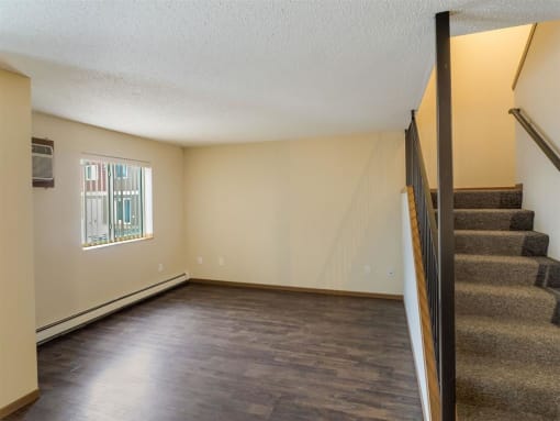 an empty living room with a staircase and a window  at Campus Park, Duluth, MN, 55811